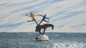 A toy cowboy, indian, and horse standing in an acrobatic formation.