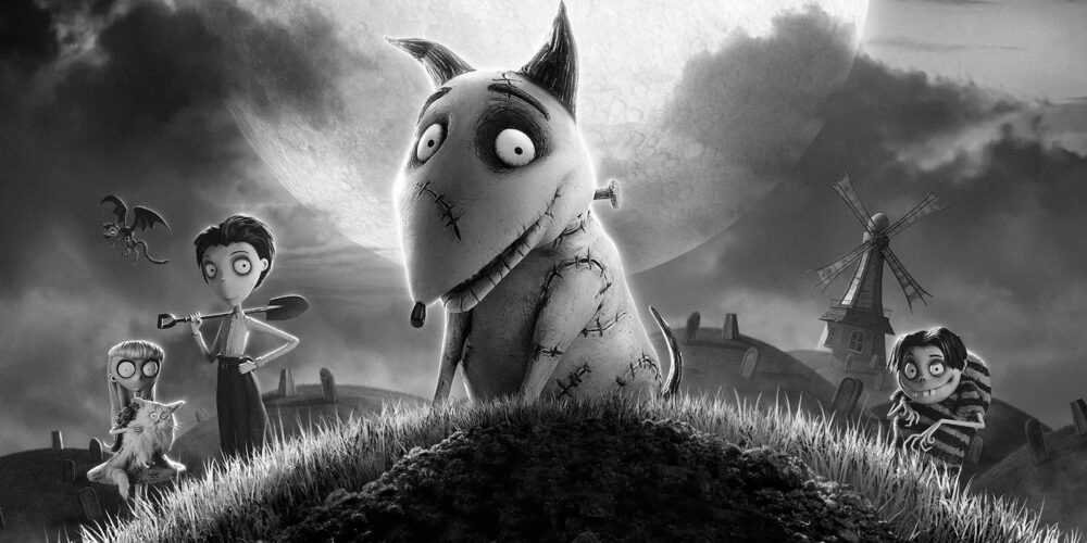 Black-and-white animated scene of a cheerful dog sitting on a grassy mound, surrounded by excited children.