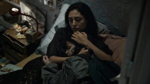 A woman comforts a younger girl