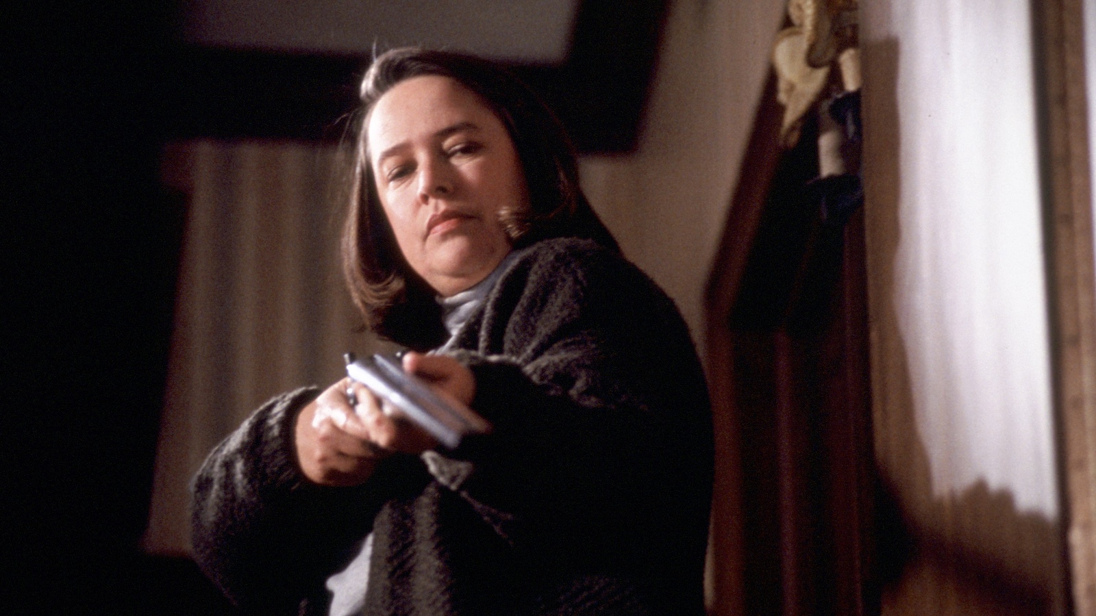 A young woman stands in a lake, getting ready to jump in.