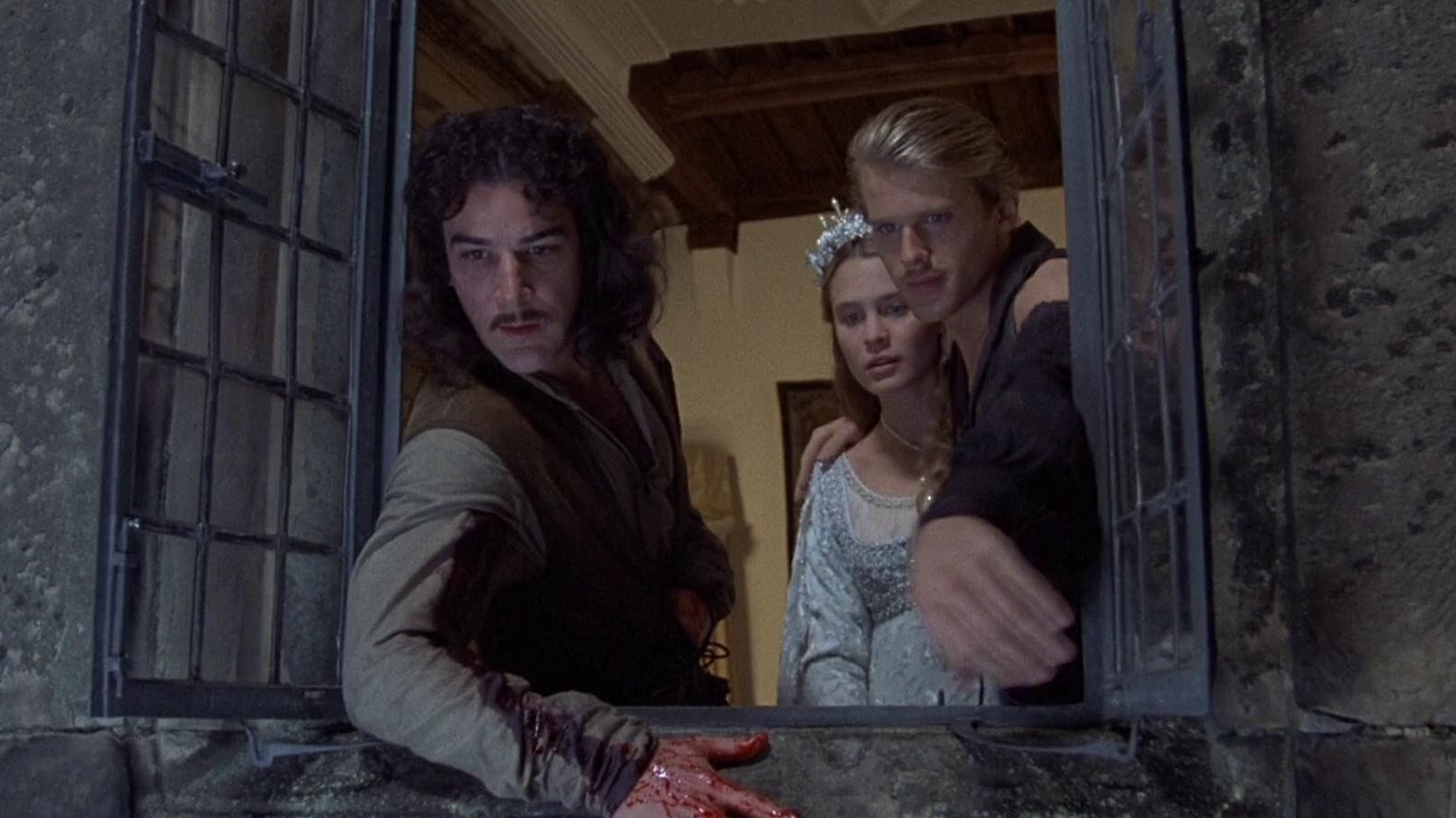 A Malian man sitting in a field in front of an orange tree.